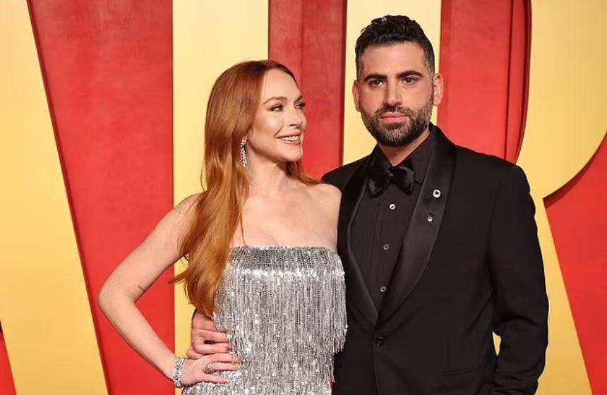 Lohan wears a silver fringed dress while Shammas dresses in a black formal suit at red carpet event in 2024